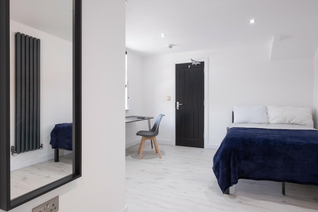Bright and spacious master bedroom featuring a ...
