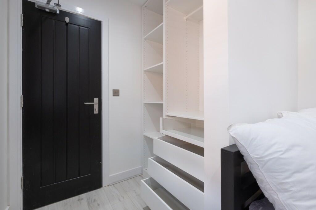 Bright and clean hallway featuring modern white...