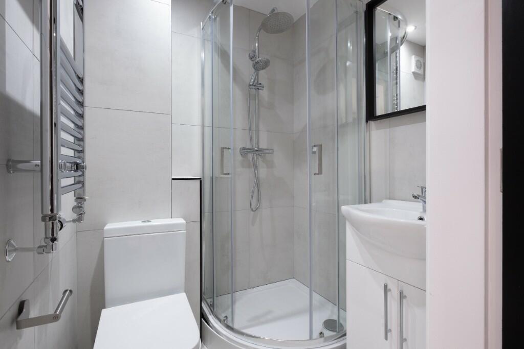 A modern and spotless bathroom suite featuring ...
