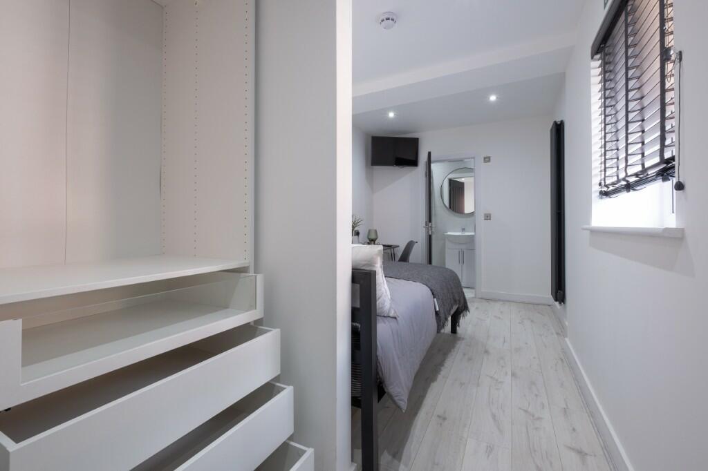 A modern double bedroom featuring a comfortable...