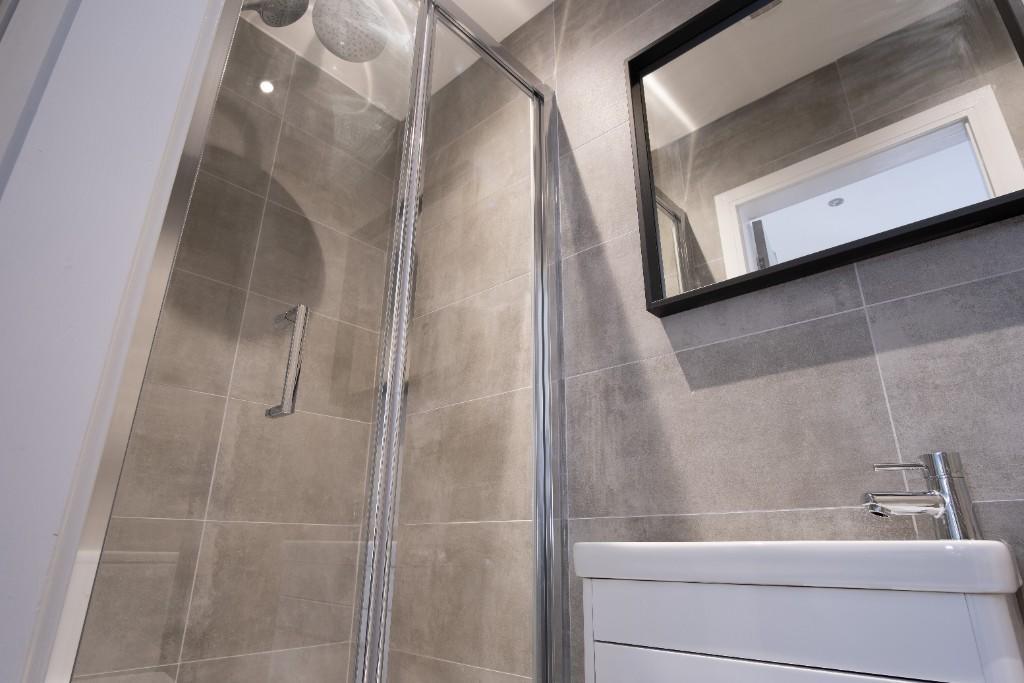Modern bathroom featuring a sleek walk-in showe...