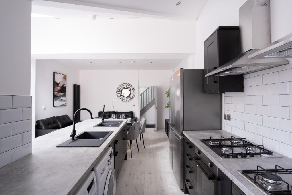 Bright and modern kitchen featuring sleek count...