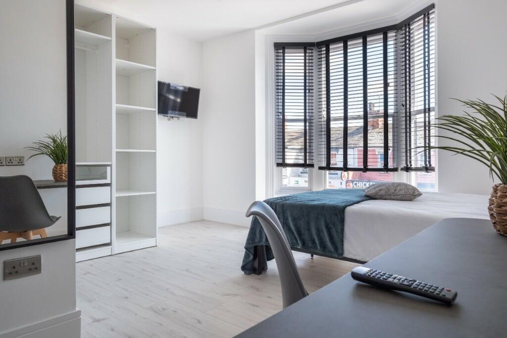 Bright and modern double bedroom featuring a la...