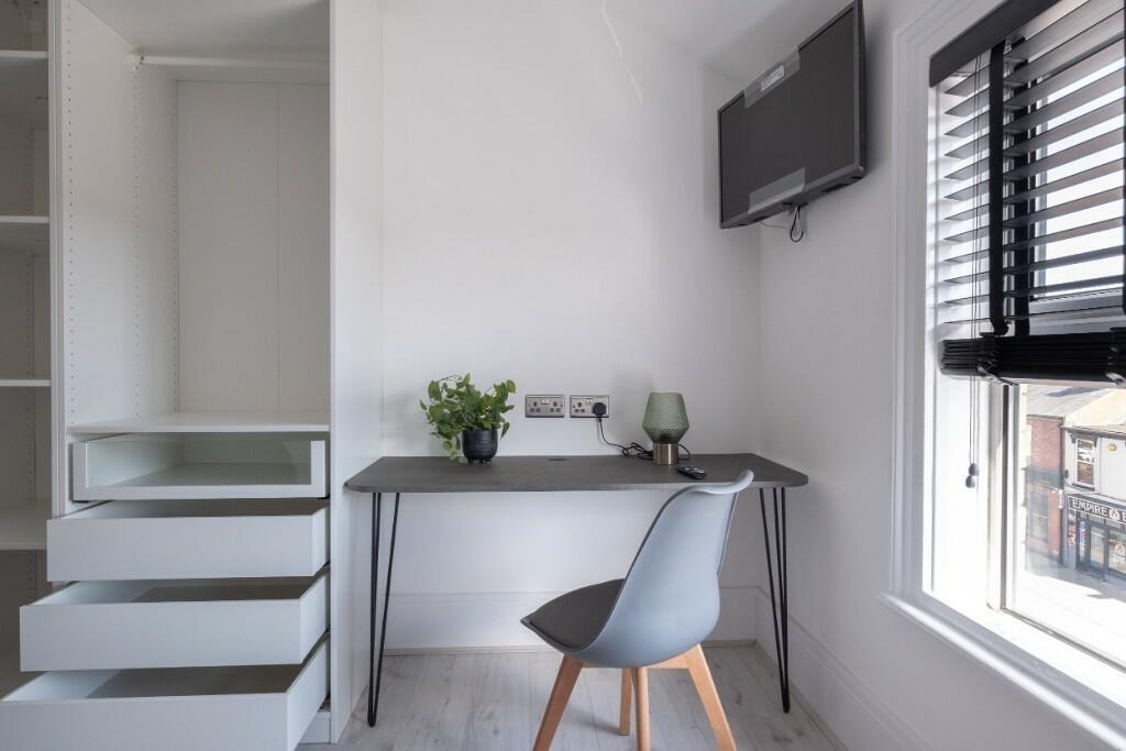 Bright and modern communal workspace featuring ...
