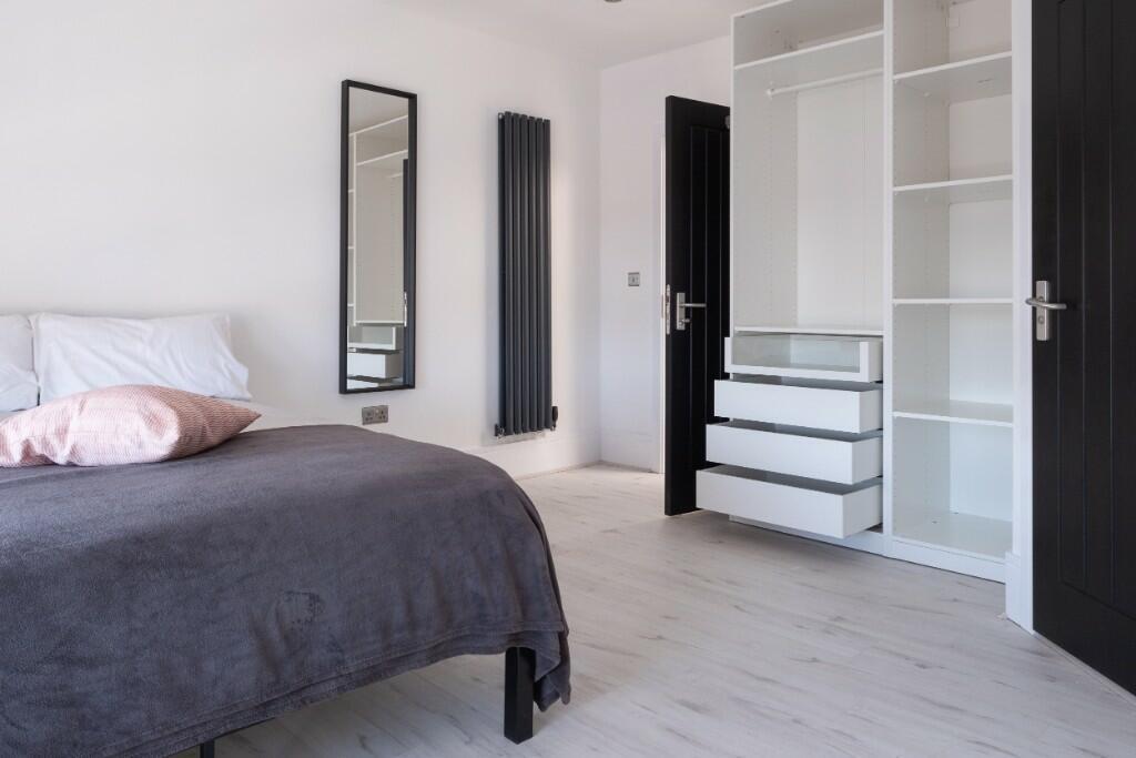 Bright and airy double bedroom featuring a comf...
