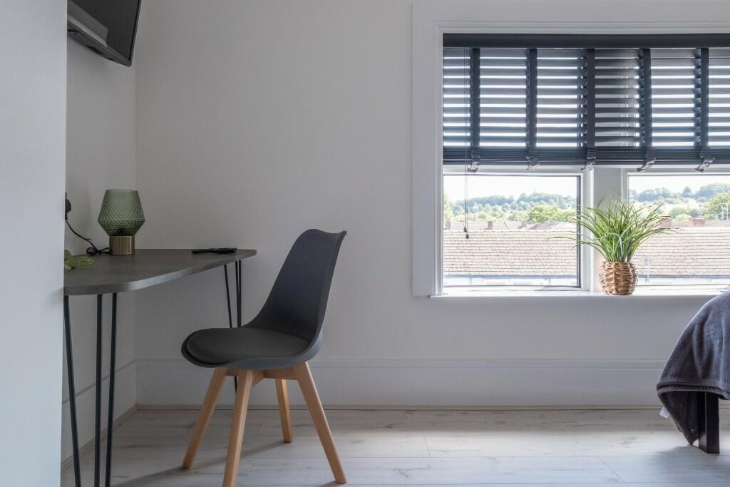 Bright and modern double bedroom featuring a la...