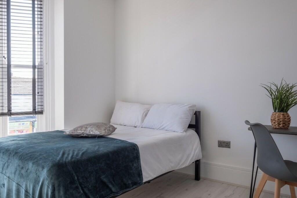 Bright and airy double bedroom featuring a comf...