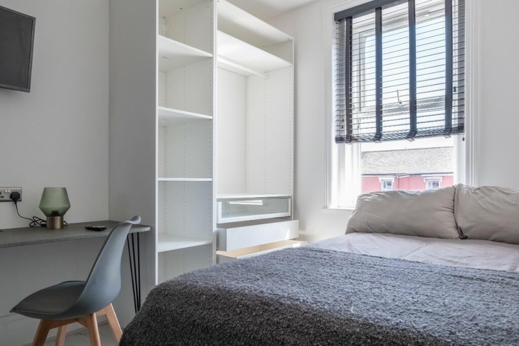 Bright and modern double bedroom featuring a co...
