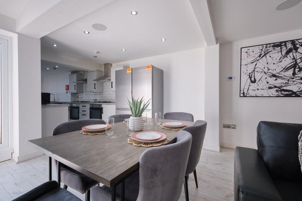A modern, well-lit living room featuring comfor...