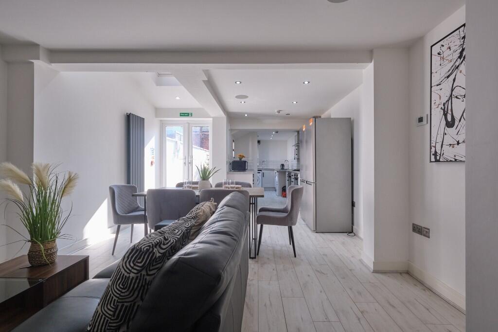 A spacious and modern living room filled with n...