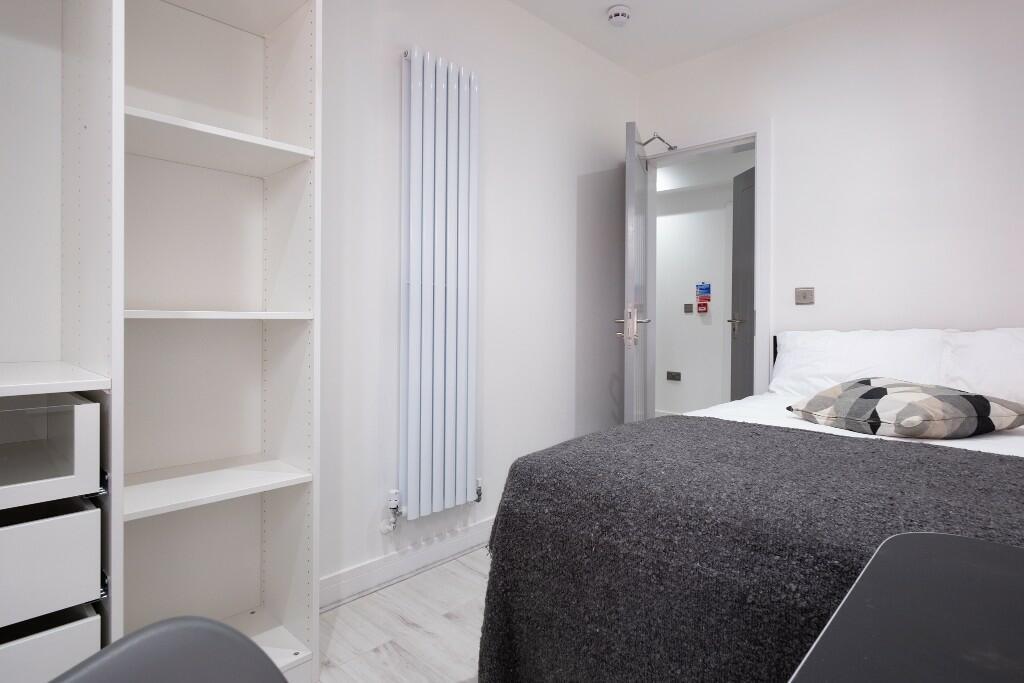 A well-maintained bedroom featuring a double be...