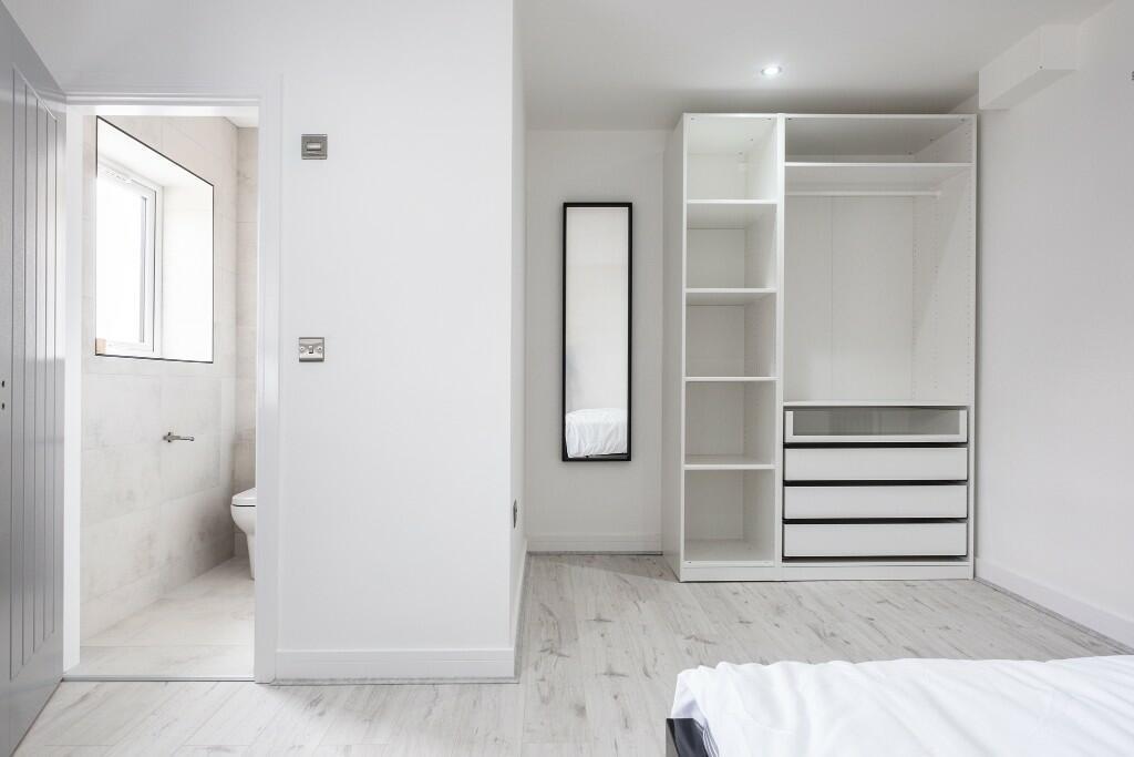 Bright, modern bedroom with built-in wardrobe, ...