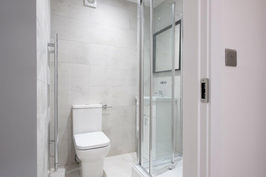 Modern and clean bathroom with a large walk-in ...
