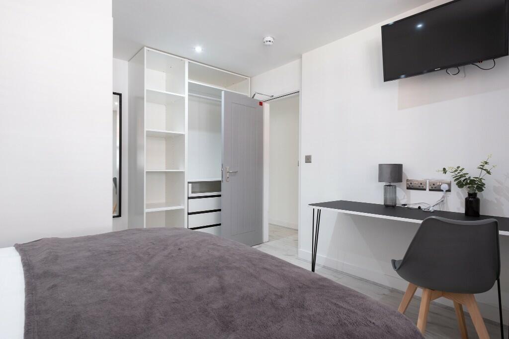 A modern, well-maintained bedroom featuring a c...