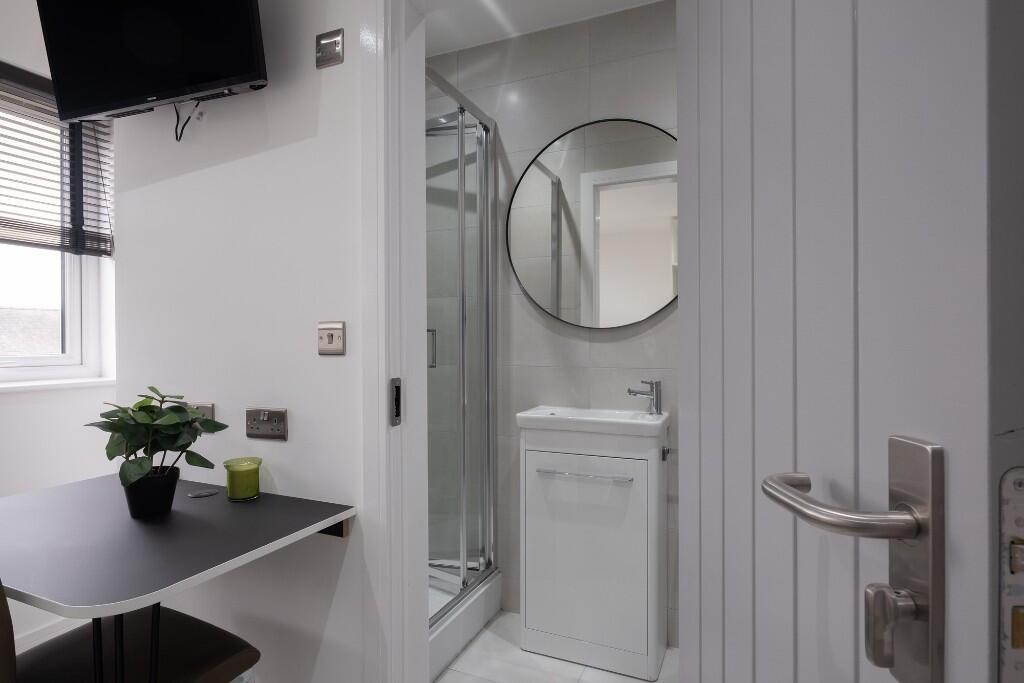 A clean and modern bathroom with a shower enclo...