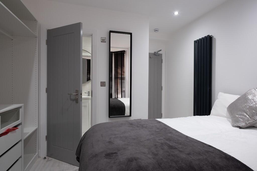 A bright and inviting double bedroom featuring ...