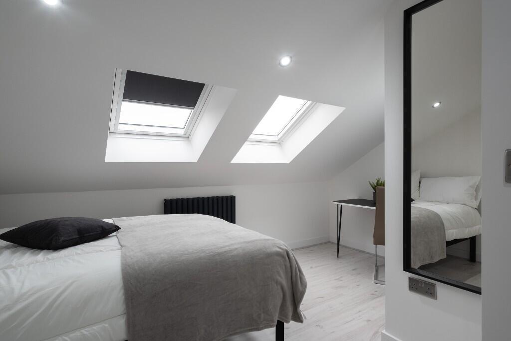 Bright and airy master bedroom with plenty of n...