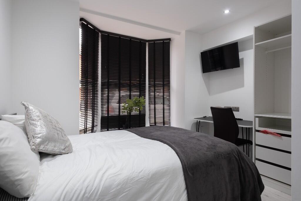 A modern, well-maintained bedroom featuring a c...