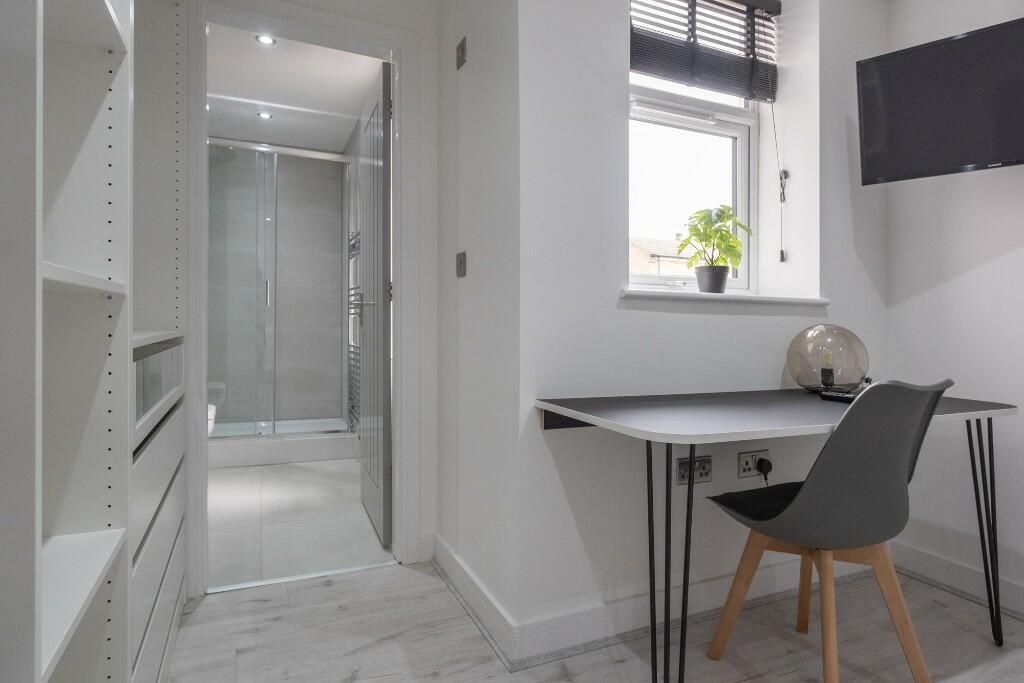 Bright and modern bathroom featuring a spacious...