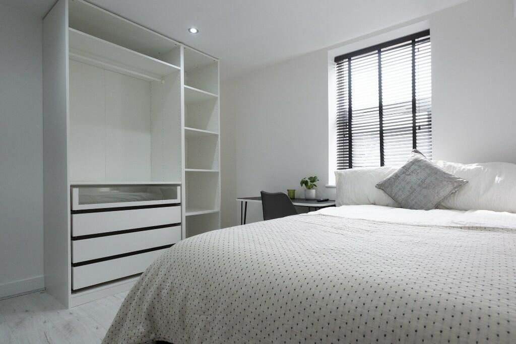 A bright and spacious master bedroom featuring ...