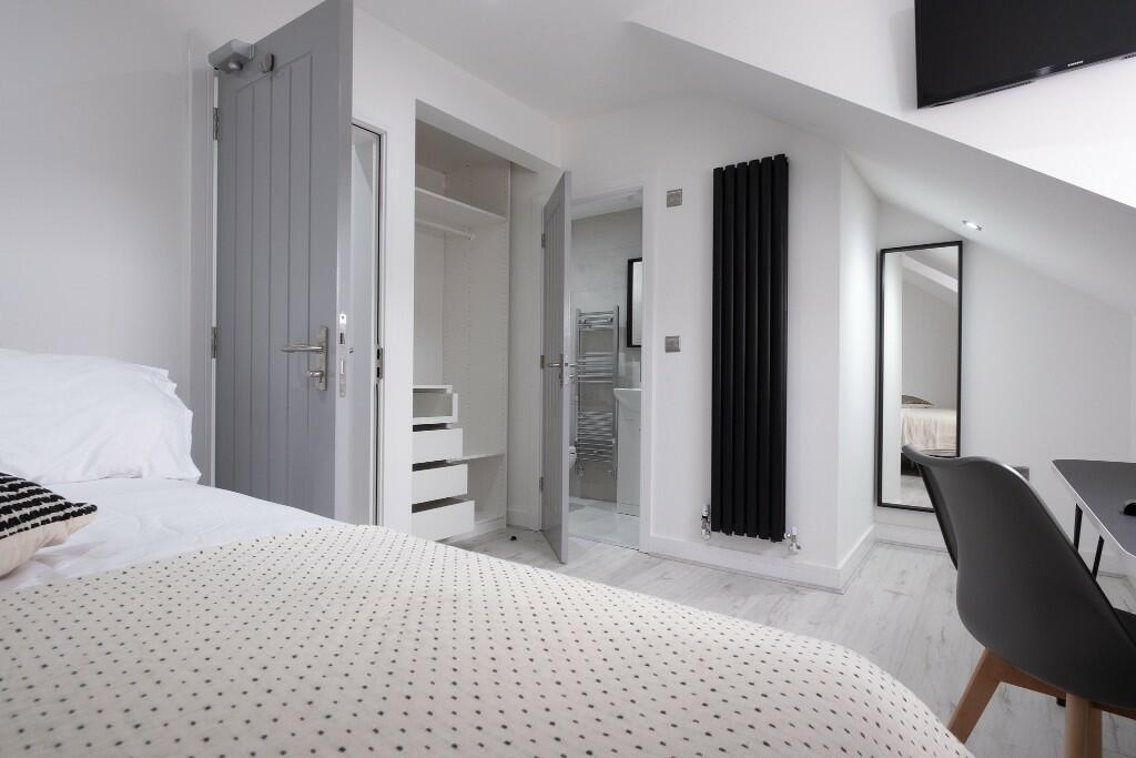 A bright and spacious master bedroom featuring ...