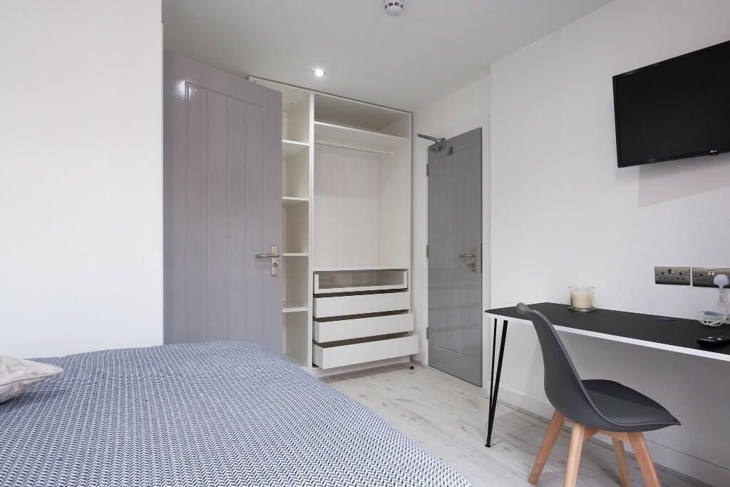 A modern, well-maintained bedroom featuring a c...