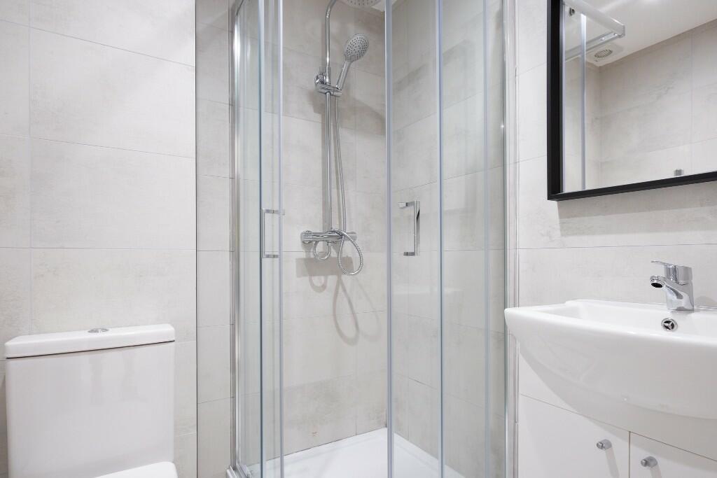 Modern and clean bathroom with a spacious showe...