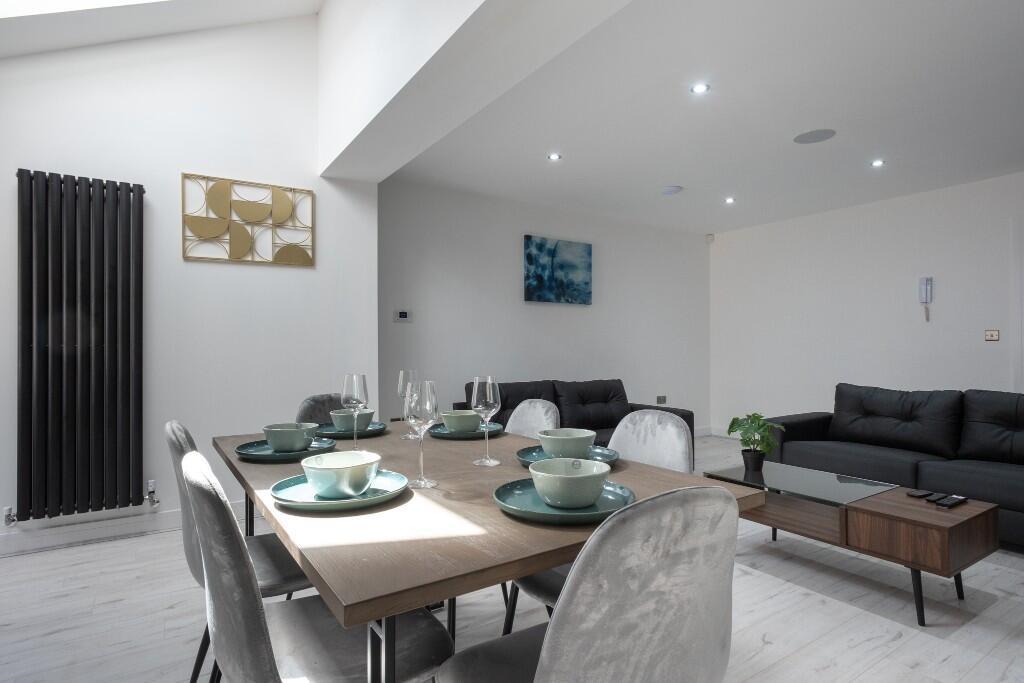 A modern and spacious living room featuring con...