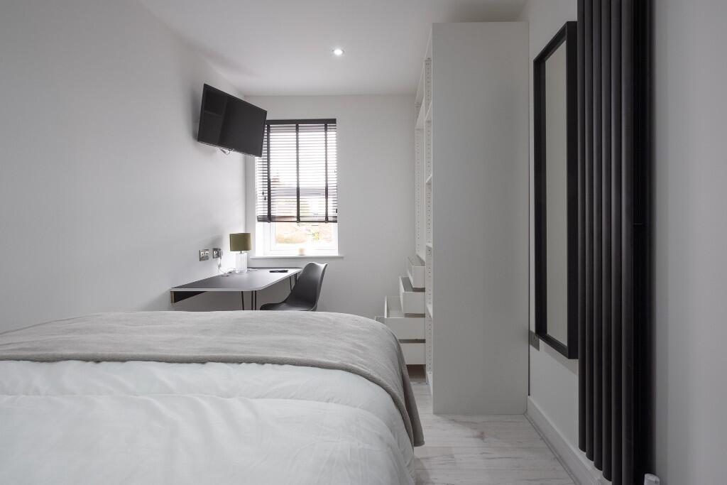 A modern, well-maintained bedroom featuring a c...