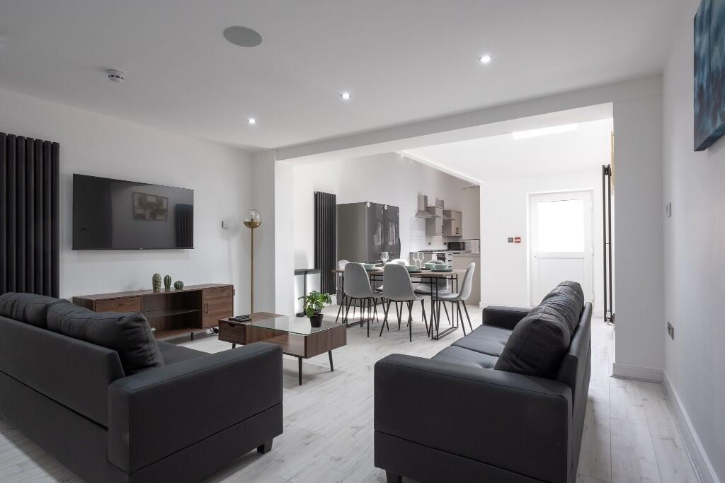 A bright and modern living room featuring comfo...