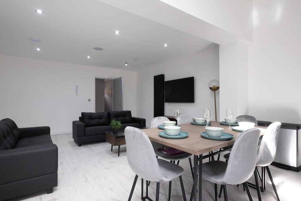 A modern and spacious living room furnished wit...