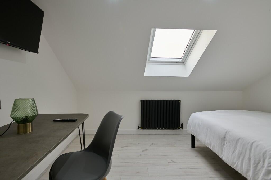 A modern, well-maintained bedroom with a comfor...