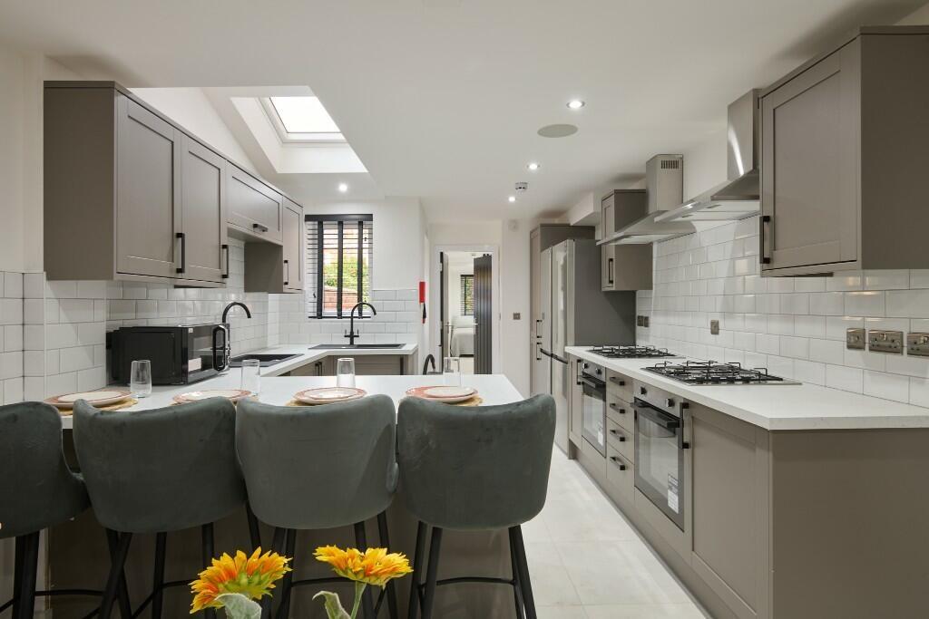 Bright and modern kitchen with ample natural li...