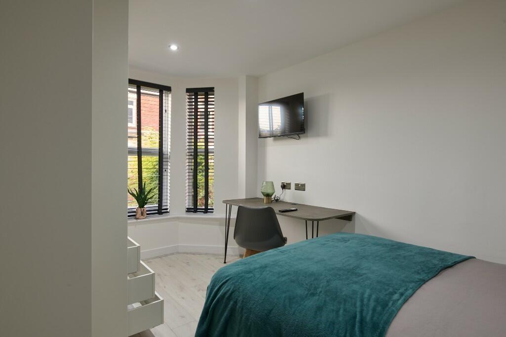 A bright and modern master bedroom featuring a ...