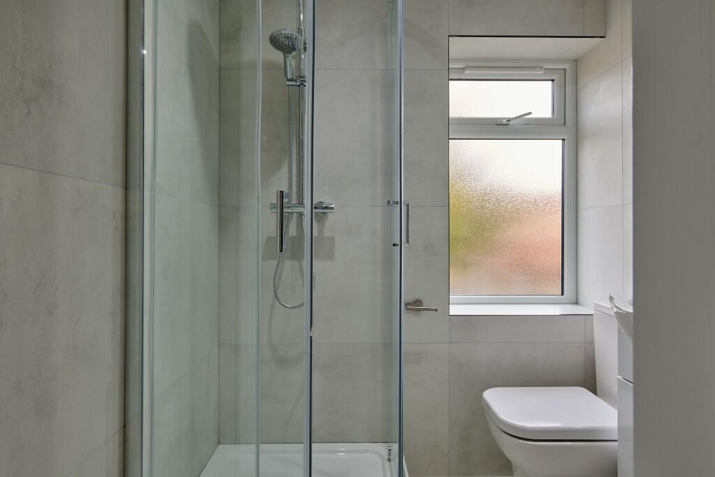 Clean and modern bathroom featuring a shower cu...