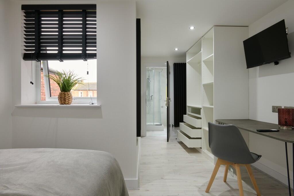 A modern, bright living room with natural light...