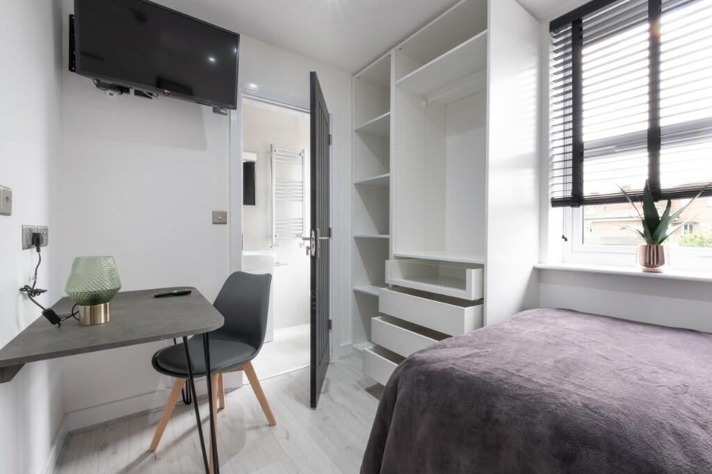 A modern and well-maintained bedroom featuring ...