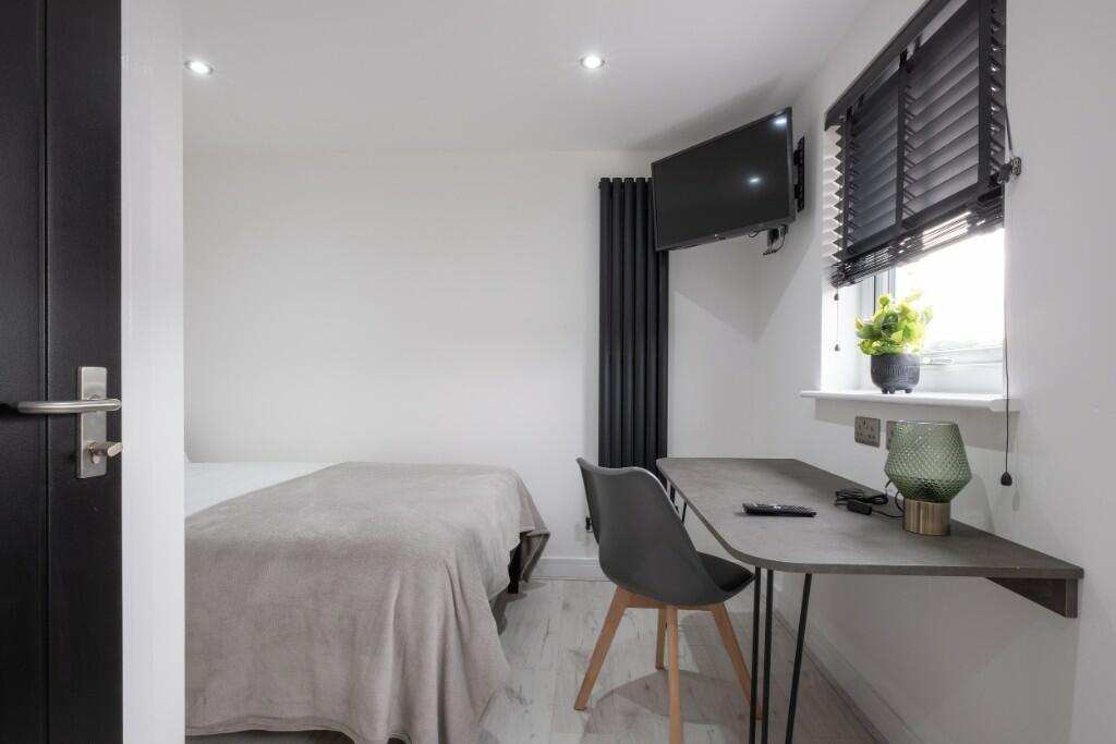A neat and bright single bedroom featuring a co...