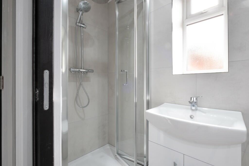 A modern, clean bathroom with a spacious shower...
