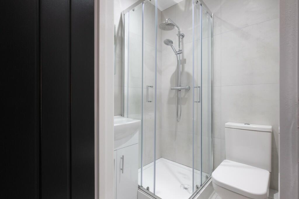 A clean and modern bathroom suite featuring a s...