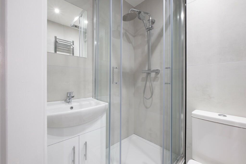 A modern, clean bathroom featuring a spacious s...