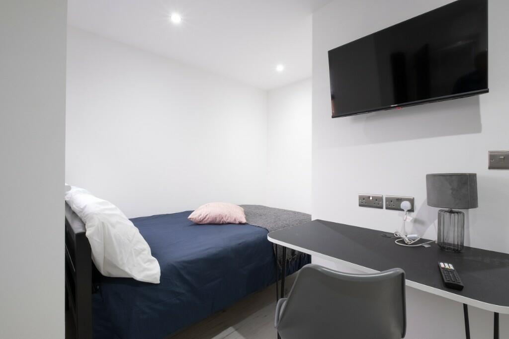 A modern, well-maintained bedroom featuring a s...
