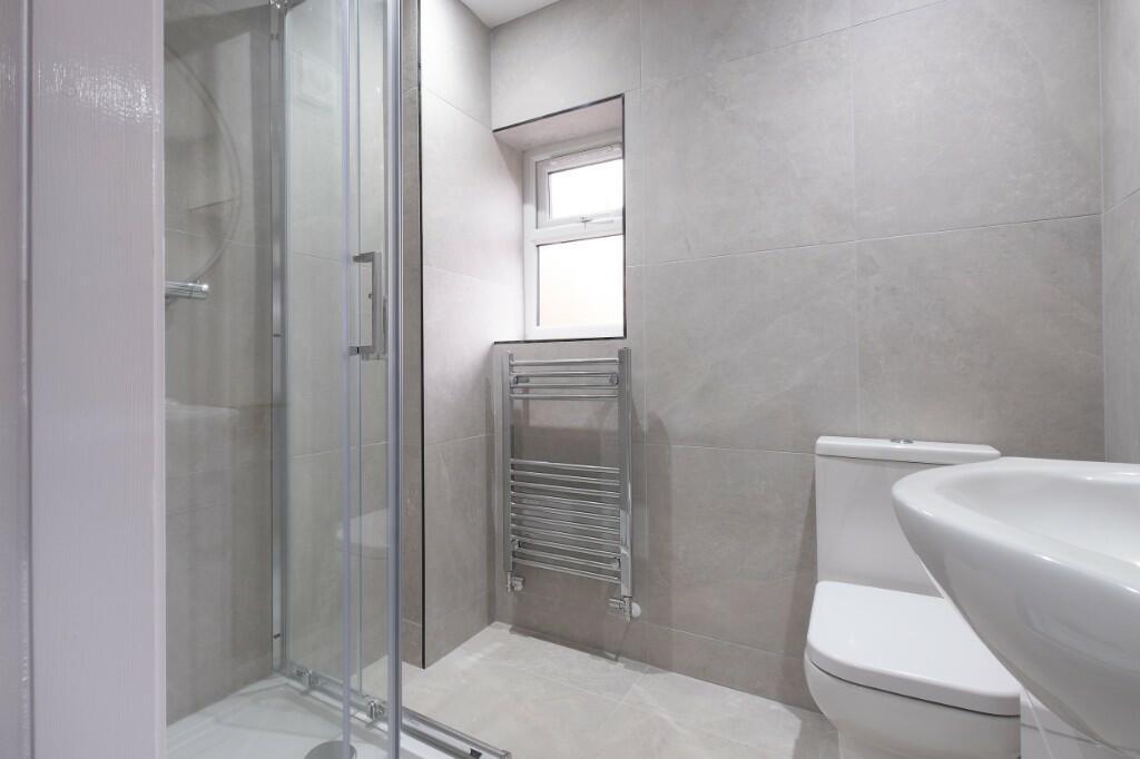 Modern and clean bathroom with a large shower e...