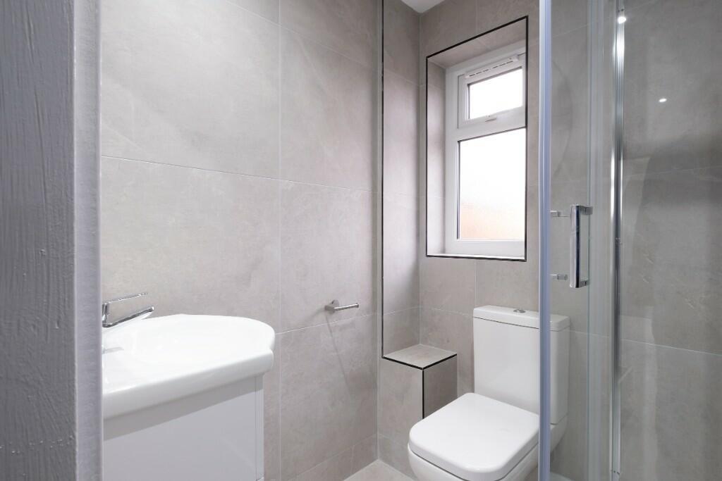 A clean, well-maintained bathroom featuring a t...
