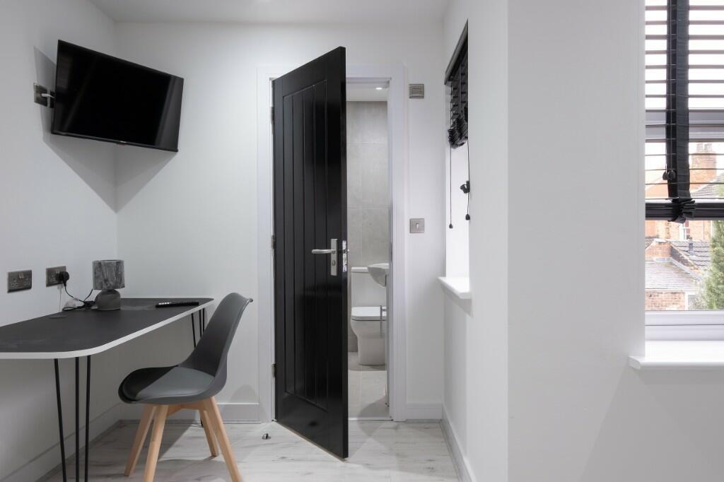 A clean and modern bathroom with a bathtub and ...