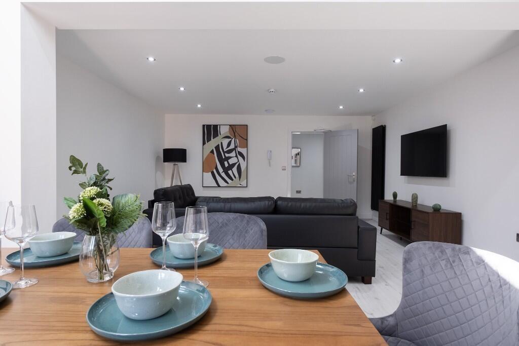 Bright and modern living room featuring contemp...
