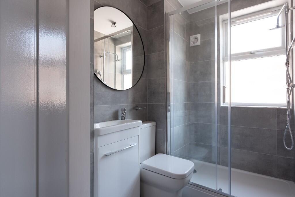 Modern, well-maintained bathroom featuring a la...