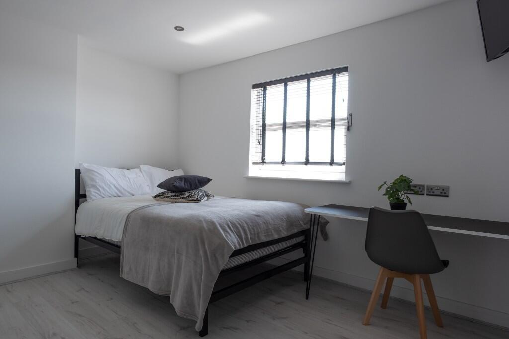 A bright and inviting double bedroom featuring ...