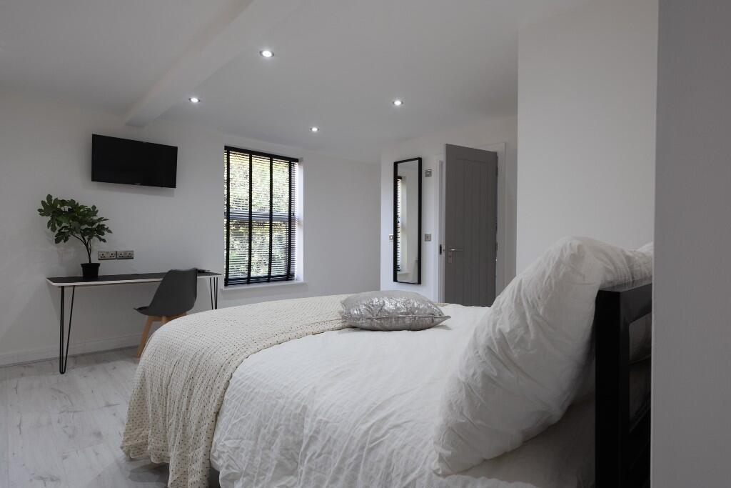 Bright and welcoming bedroom featuring a comfor...