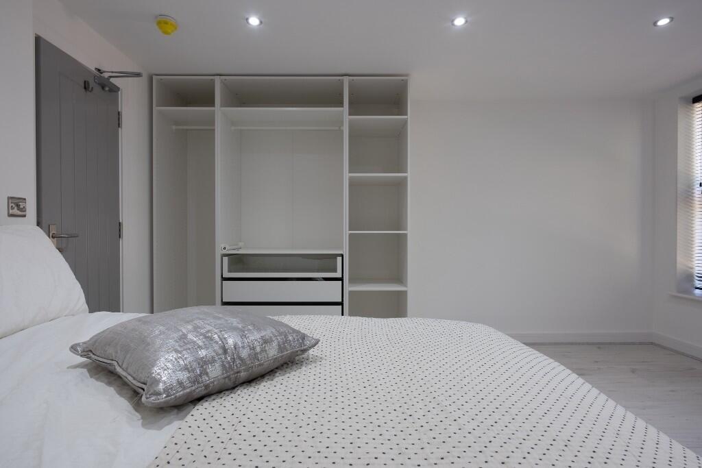 Spacious master bedroom featuring a comfortable...